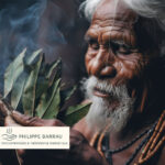 Portrait symbolique d’un chaman aborigène d’Australie tenant des feuilles médicinales, représentant la sagesse ancestrale et la pratique énergétique – Philippe Barrau, psychopraticien et thérapeute énergétique à Saint-Rémy-de-Provence.